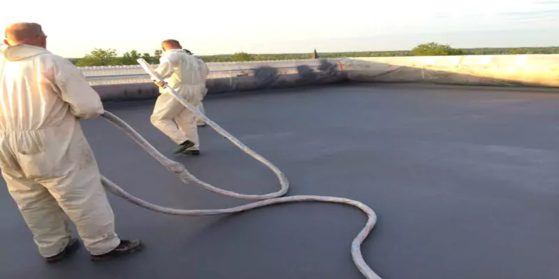 Applicator spraying a polyurea floor lining