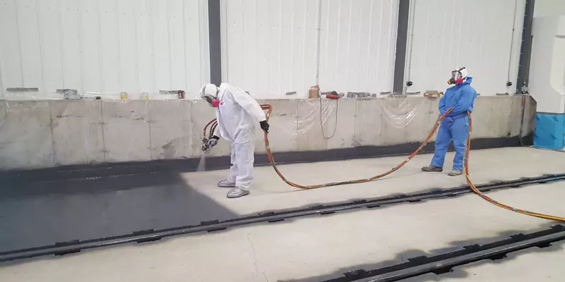 Floors & spill pads coated with polyurea