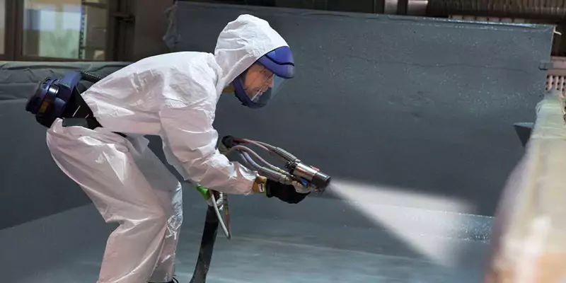 Polyurea spray application inside a concrete containment area
